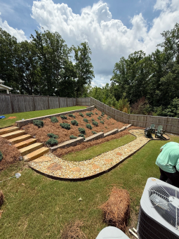 Terraced landscaping installation featuring stone steps and a gravel pathway by A.SCAPINGS